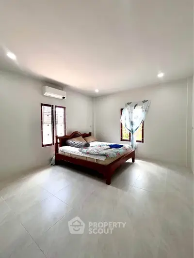 Spacious bedroom with natural light and minimalist decor