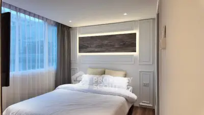 Cozy modern bedroom with elegant lighting and large window
