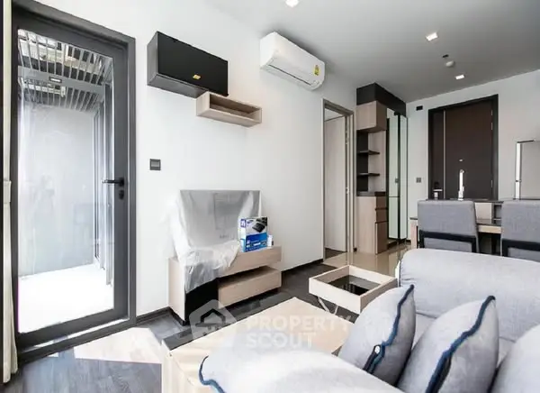 Modern living room with sleek furniture and air conditioning in a bright apartment.