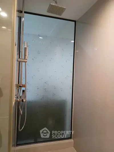 Modern bathroom with sleek shower and frosted glass panel