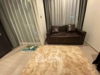 Cozy living room with plush rug and leather sofa, perfect for relaxation.