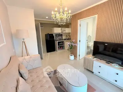 Elegant living room with chandelier and modern open kitchen layout