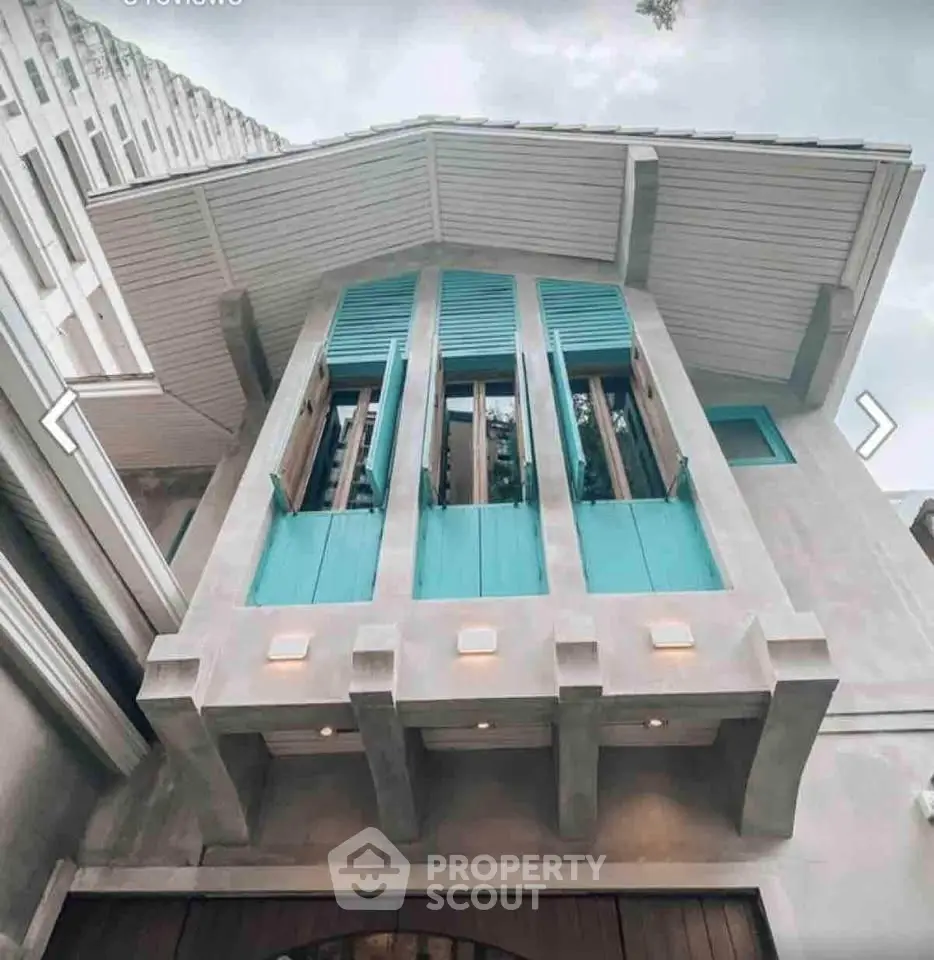 Stunning architectural exterior with unique design and vibrant blue accents, perfect for modern urban living.