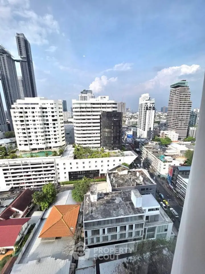 Stunning cityscape view from high-rise apartment showcasing urban skyline and modern architecture.