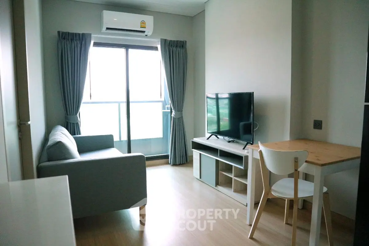 Modern living room with sleek furniture and natural light in a stylish apartment.