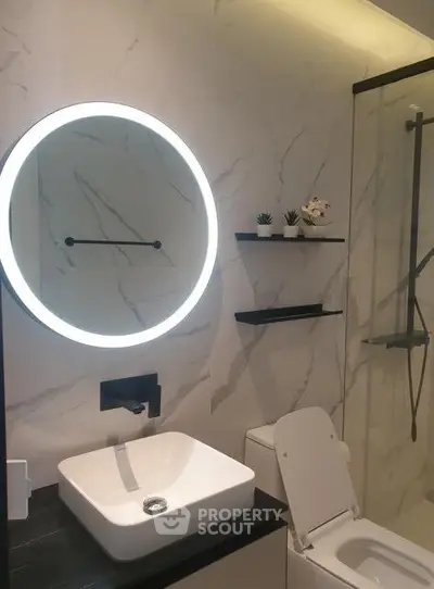 Modern bathroom with illuminated mirror and sleek fixtures