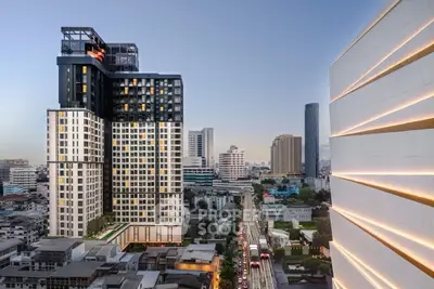 Stunning cityscape view of modern high-rise buildings at dusk, showcasing urban living and architectural elegance.