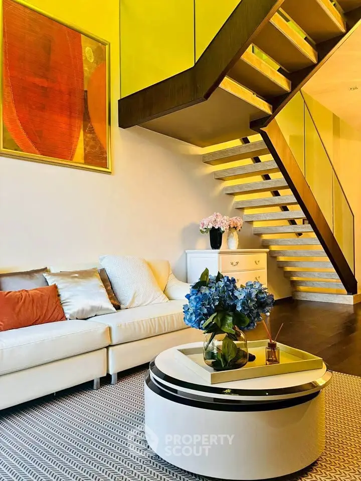 Modern living room with stylish staircase and elegant decor