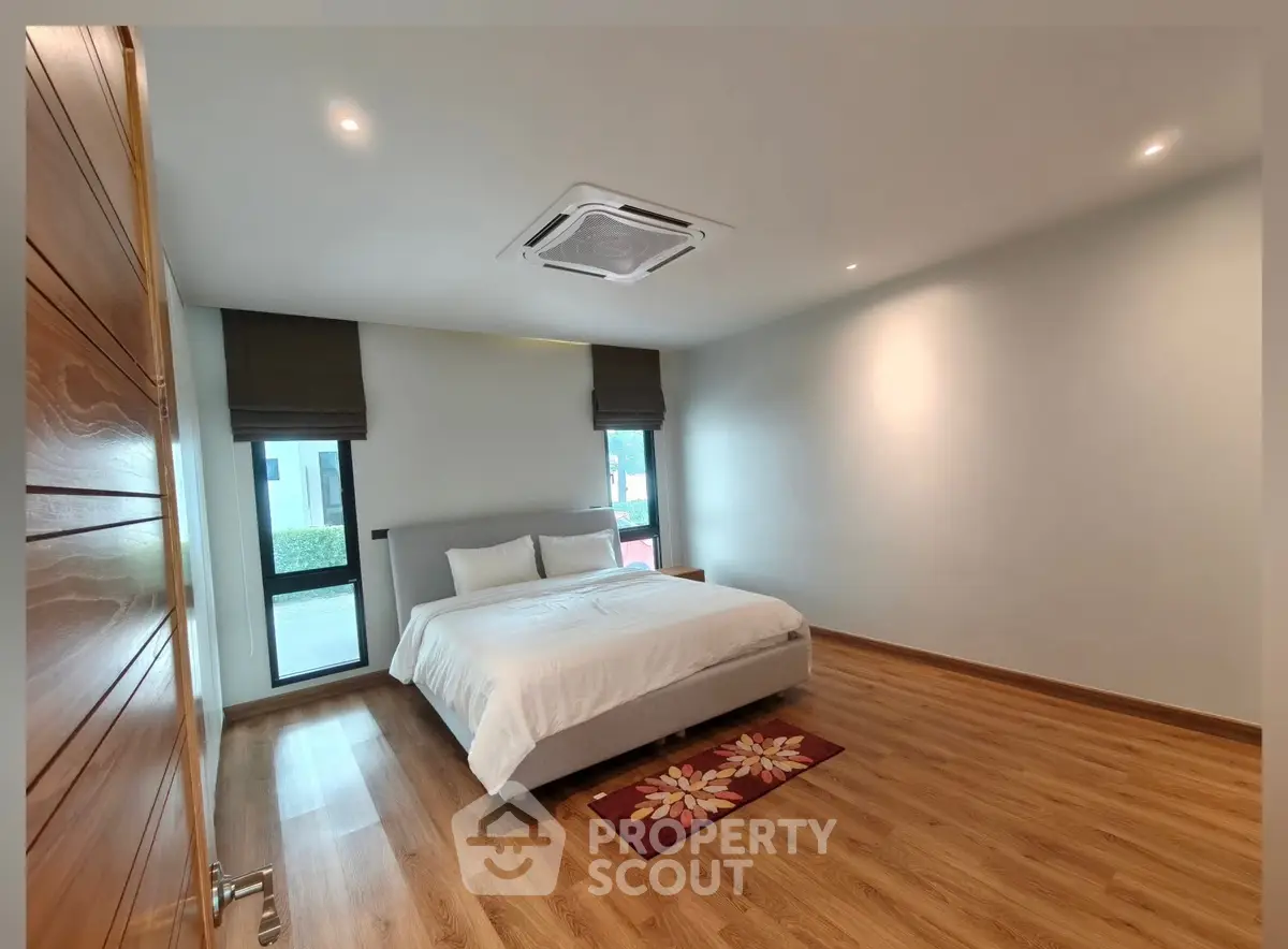 Spacious bedroom with modern design and wooden flooring