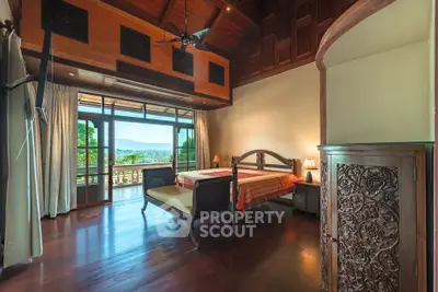 Luxurious bedroom with wooden decor and stunning balcony view