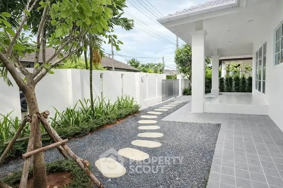 Charming modern home exterior with landscaped garden and stylish walkway
