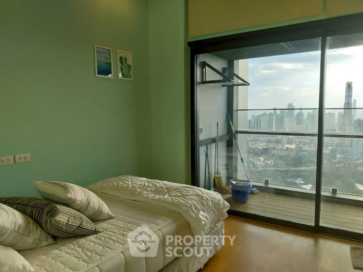 Modern bedroom with stunning city view from large balcony window