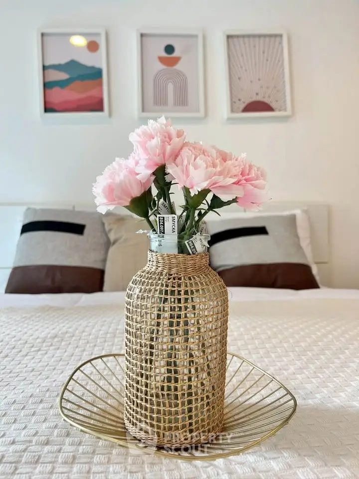Stylish bedroom with decorative vase and modern art, perfect for cozy living.
