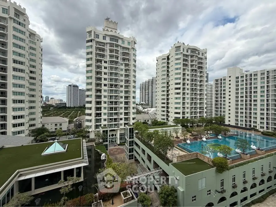 Luxurious high-rise apartment complex with pool and garden views
