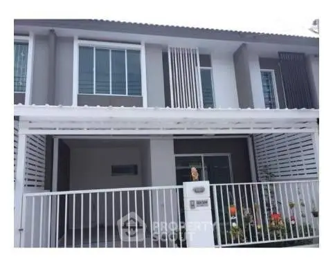 Modern townhouse exterior with sleek design and gated entrance