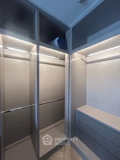 Spacious walk-in closet with modern shelving and lighting