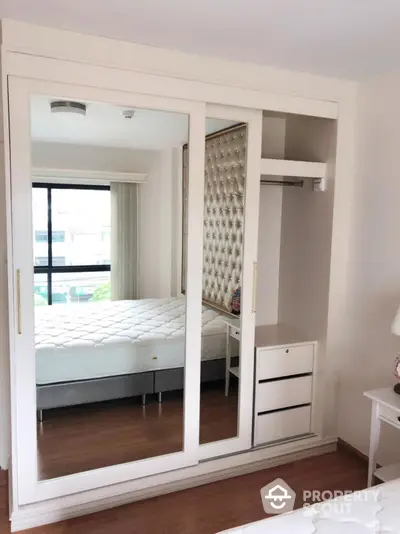 Modern bedroom with mirrored wardrobe and elegant decor