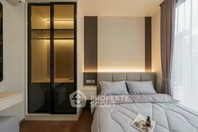 Modern bedroom with sleek design and cozy ambiance, featuring a stylish bed and built-in closet.