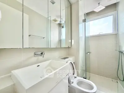 Modern bathroom with sleek fixtures and glass shower enclosure