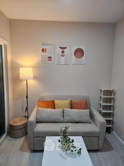 Cozy living room with modern decor and neutral tones, featuring a comfortable sofa and stylish wall art.