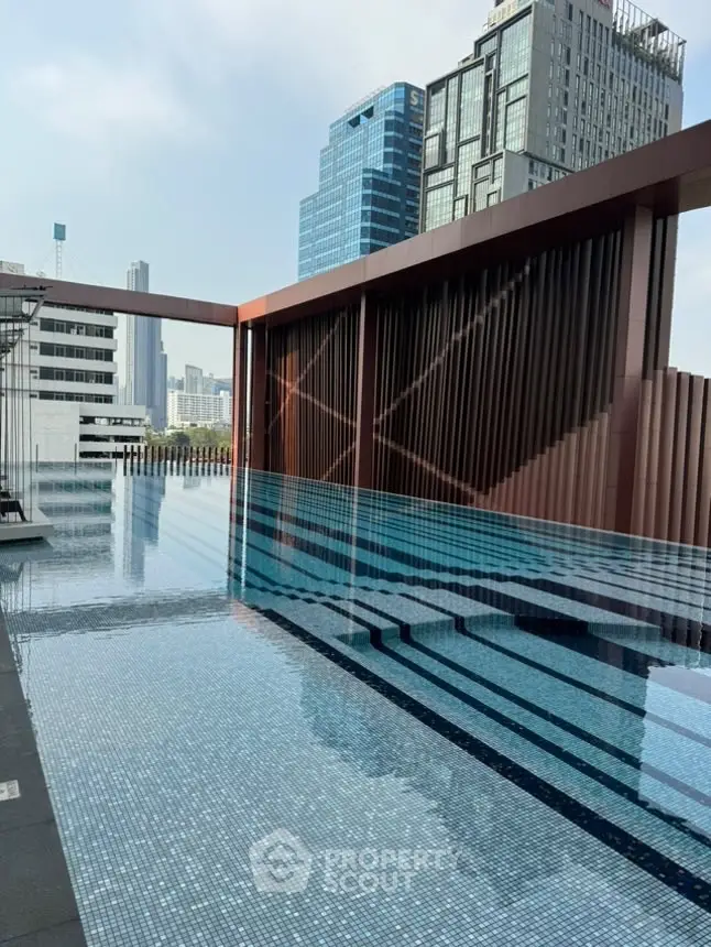 Luxurious rooftop pool with stunning city skyline views in modern high-rise building.
