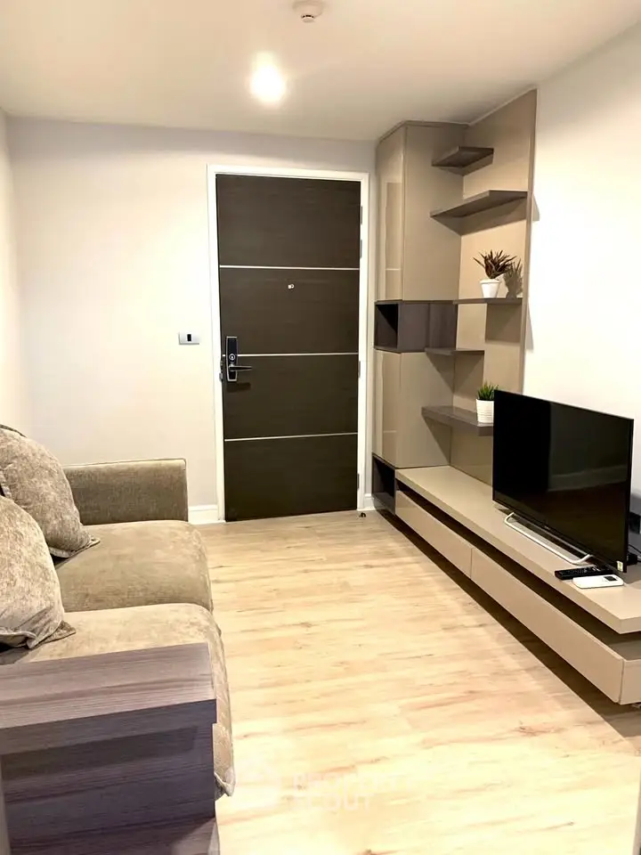 Modern living room with cozy sofa and sleek TV unit, perfect for relaxation.