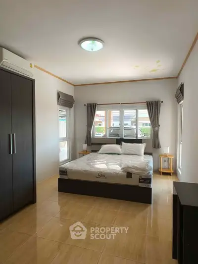 Spacious bedroom with modern furnishings and natural light