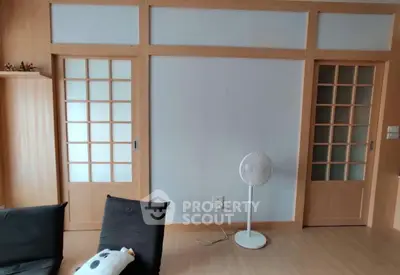 Modern living room with sliding wooden doors and minimalist decor