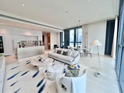 Luxurious open-plan living room with modern kitchen and stunning city views.