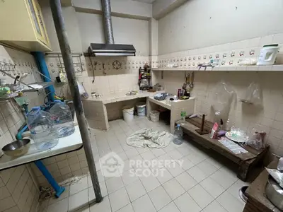 Spacious kitchen with tiled walls and ample storage space