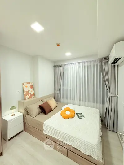 Cozy bedroom with modern decor and natural light, featuring a comfortable bed and stylish furnishings.