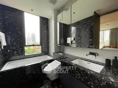 Luxurious modern bathroom with city view, featuring sleek black marble finishes and large window.