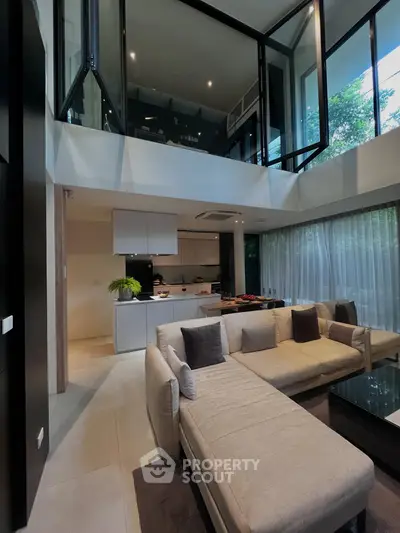 Luxurious modern living room with open kitchen and high ceiling design