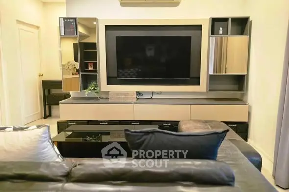 Modern living room with sleek entertainment center and cozy seating