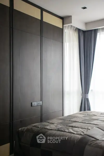 Modern bedroom with sleek dark wood paneling and large window with curtains