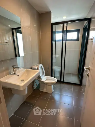 Modern bathroom with sleek fixtures and glass shower enclosure