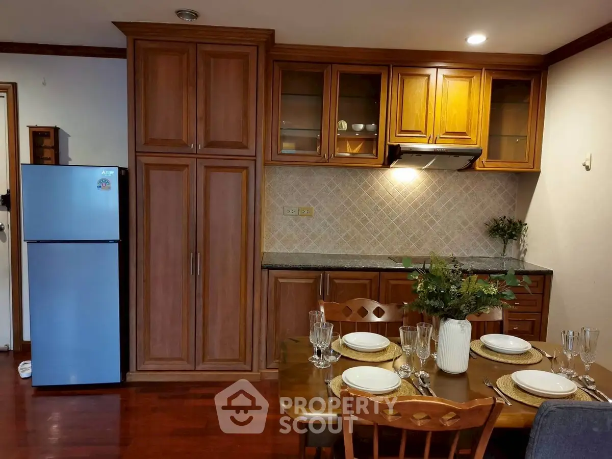 Charming kitchen with wooden cabinets and dining setup, perfect for cozy family meals.