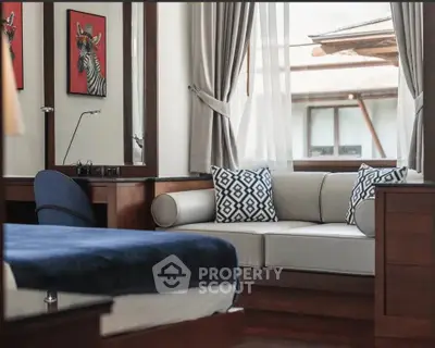 Luxurious bedroom with elegant decor and cozy seating area, perfect for relaxation.