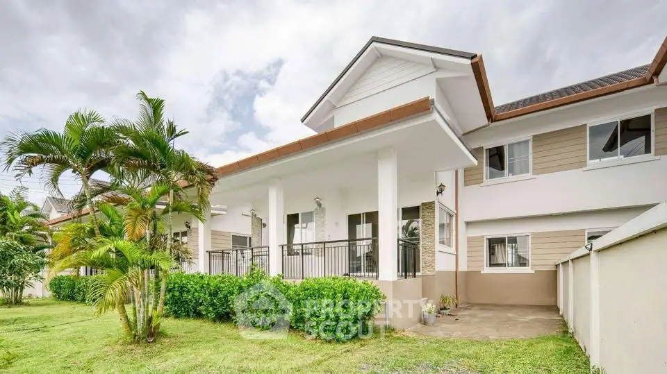 Elegant two-story house with lush garden and spacious balcony.