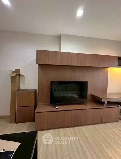 Modern living room with sleek wooden TV unit and ambient lighting