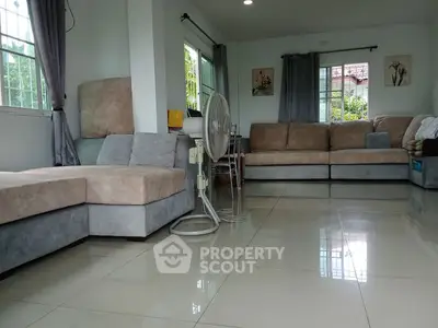 Spacious living room with modern furniture and large windows for natural light.