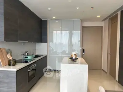 Modern kitchen with sleek cabinetry and island in a stylish apartment.