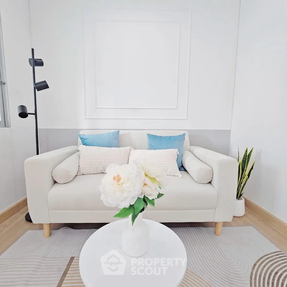 Chic and cozy living room with modern white sofa and stylish decor
