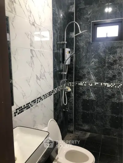 Modern bathroom with marble tiles and sleek shower design