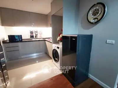 Modern kitchen with sleek cabinetry and built-in washing machine