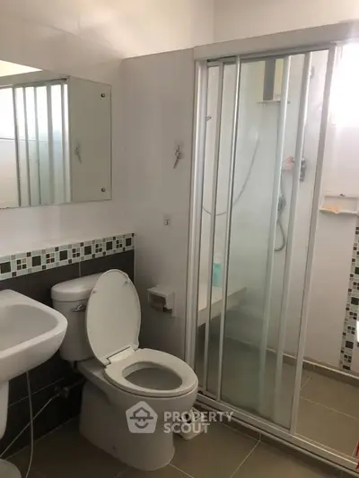Modern bathroom with shower enclosure and stylish tile accents