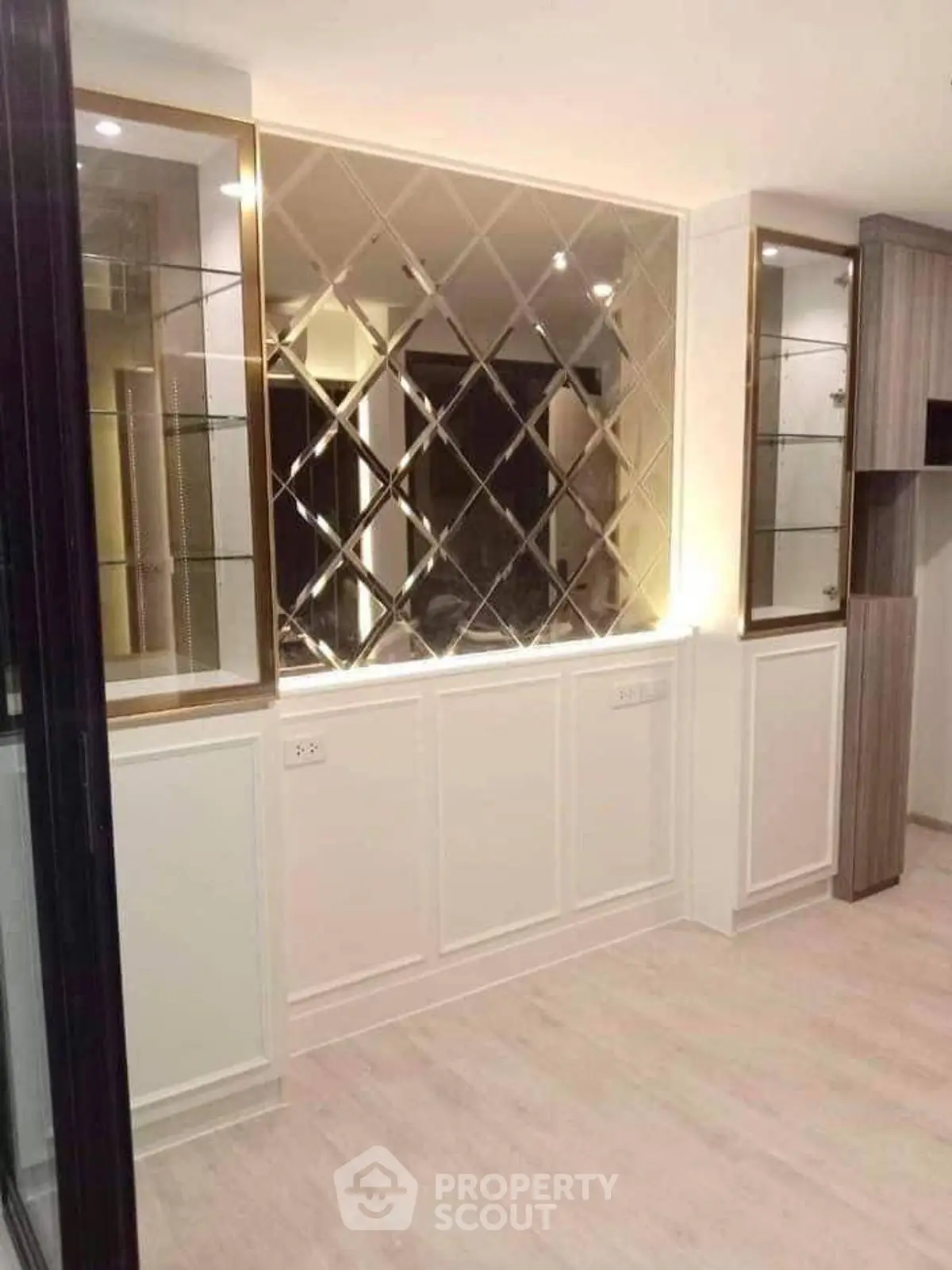 Elegant interior with mirrored wall and built-in shelving, perfect for modern living spaces.