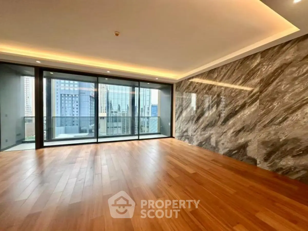 Spacious modern living room with wooden flooring and city view balcony