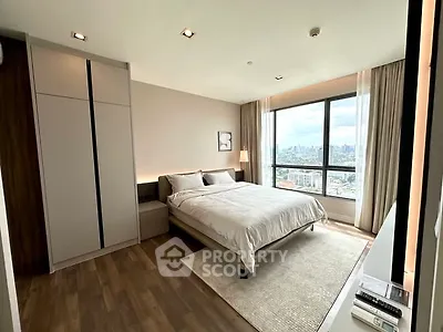 Modern bedroom with city view, large window, and sleek design