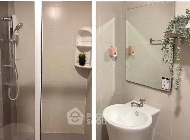 Modern bathroom with shower and sleek sink, featuring minimalist design and greenery accent.